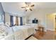 Bright and airy bedroom with hardwood floors, ceiling fan, and ensuite bath at 2415 Clock Face Ct, Lawrenceville, GA 30043