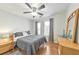 Cozy bedroom with a neutral color palette, ceiling fan, and natural light at 2415 Clock Face Ct, Lawrenceville, GA 30043