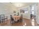 Elegant dining room with hardwood floors, stylish chandelier, and view into the kitchen at 2415 Clock Face Ct, Lawrenceville, GA 30043