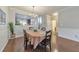 Inviting dining area with hardwood floors, elegant lighting, and neutral decor at 2415 Clock Face Ct, Lawrenceville, GA 30043