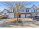 Charming townhouse with a well-manicured lawn, attached garage, and inviting curb appeal at 2415 Clock Face Ct, Lawrenceville, GA 30043