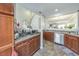 Functional kitchen featuring stainless steel appliances, dark cabinets, and tiled floors at 2415 Clock Face Ct, Lawrenceville, GA 30043