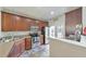 Well-lit kitchen with stainless steel appliances and cherry cabinets, offers great counter space at 2415 Clock Face Ct, Lawrenceville, GA 30043