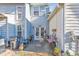 A cozy outdoor patio featuring seating, potted plants, and a double door entrance to the home at 2415 Clock Face Ct, Lawrenceville, GA 30043