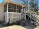 View of the house's backyard, featuring a screened-in porch and a detached staircase at 2475 Freydale Se Rd, Marietta, GA 30067