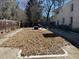 An eye-level shot of the backyard, showing a large yard covered with leaves, and the side of the home at 2475 Freydale Se Rd, Marietta, GA 30067