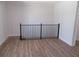 Open loft area with modern black iron railing and beautiful light-colored wood flooring at 2475 Freydale Se Rd, Marietta, GA 30067