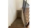 Wooden staircase with modern black iron railing leading down to an unfinished basement at 2475 Freydale Se Rd, Marietta, GA 30067