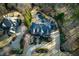 Aerial view of the beautiful two-story home featuring a circular driveway and manicured landscaping at 3180 Wills Mill Rd, Cumming, GA 30041