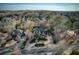 Aerial view of the beautiful two-story home, circular driveway, and surrounding mature trees at 3180 Wills Mill Rd, Cumming, GA 30041