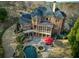 Aerial view showcasing the backyard's pool, spa, patio, and the home's screened porch at 3180 Wills Mill Rd, Cumming, GA 30041