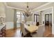 Bright dining room with hardwood floors, chandelier, and view into the foyer at 3180 Wills Mill Rd, Cumming, GA 30041