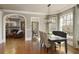 Dining room with natural light, modern lighting fixture, and direct access to the living room at 3180 Wills Mill Rd, Cumming, GA 30041