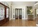 Elegant foyer with hardwood floors, decorative millwork, and view to the French doors at 3180 Wills Mill Rd, Cumming, GA 30041