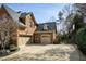 Home exterior with a three-car garage, a basketball hoop and an extensive driveway for parking at 3180 Wills Mill Rd, Cumming, GA 30041