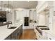 Modern kitchen with white cabinetry, stainless steel appliances and hardwood floors at 3180 Wills Mill Rd, Cumming, GA 30041