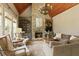 Cozy living room with stone fireplace, built-in shelving, natural light and wood ceiling at 3180 Wills Mill Rd, Cumming, GA 30041