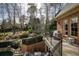 Balcony view of the outdoor kitchen bar with grill and the surrounding manicured landscaping at 3180 Wills Mill Rd, Cumming, GA 30041