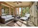 Sunroom featuring a ceiling fan and wicker sofa at 3180 Wills Mill Rd, Cumming, GA 30041