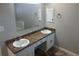 Bathroom with a dual sink vanity, large mirror and white cabinets at 503 N Shore Rd, Lithonia, GA 30058