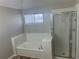 Bright bathroom featuring a separate glass shower and a relaxing soaking tub at 503 N Shore Rd, Lithonia, GA 30058