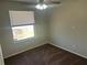 Well-lit bedroom with a window overlooking the fenced backyard and neutral carpeting at 503 N Shore Rd, Lithonia, GA 30058