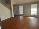 Open living space with wood flooring and ample natural light from large windows at 503 N Shore Rd, Lithonia, GA 30058