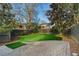 The backyard features neatly manicured grass with a stone patio area and a wood fence at 648 Cooledge Ave, Atlanta, GA 30306