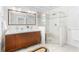 This bathroom features a double sink vanity, a large mirror, and a glass enclosed shower with white tiling at 648 Cooledge Ave, Atlanta, GA 30306