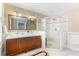 Bright bathroom featuring a glass shower, double sinks, and large mirror with modern fixtures at 648 Cooledge Ave, Atlanta, GA 30306