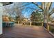 Spacious wooden deck with a table and chairs surrounded by lush trees and a railing at 648 Cooledge Ave, Atlanta, GA 30306