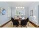 Elegant dining room featuring a wooden table, chairs, and modern lighting fixture at 648 Cooledge Ave, Atlanta, GA 30306