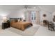 This main bedroom features neutral walls, ceiling fan, accent rug, and a seating area near a window with natural light at 648 Cooledge Ave, Atlanta, GA 30306