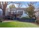 This home's rear exterior features a raised deck, a fenced yard, and manicured grass at 648 Cooledge Ave, Atlanta, GA 30306