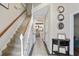 Grand entryway with staircase, stylish console table, and a view into the kitchen at 76 Barrington Farms Pkwy, Sharpsburg, GA 30277