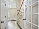 Inviting foyer featuring a staircase, tiled flooring, and a bright, airy atmosphere at 76 Barrington Farms Pkwy, Sharpsburg, GA 30277