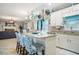 Stylish kitchen island with granite countertops, seating, and views into the living room at 76 Barrington Farms Pkwy, Sharpsburg, GA 30277