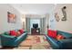 Cozy living room with bay window, decorative rug, and matching sofas with vibrant pillows at 76 Barrington Farms Pkwy, Sharpsburg, GA 30277