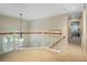 Open loft area with carpeted floors, white railings, and natural light from a window, creating a cozy space at 76 Barrington Farms Pkwy, Sharpsburg, GA 30277