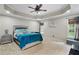 Serene main bedroom featuring a tray ceiling, recessed lighting, and large windows at 76 Barrington Farms Pkwy, Sharpsburg, GA 30277