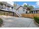 Backyard showing a stone house with a black building supported by posts and stairs at 124 The Prado, Atlanta, GA 30309