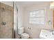Bathroom featuring a shower, window, toilet, and sink with tile flooring at 124 The Prado, Atlanta, GA 30309