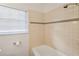 Bright bathroom featuring white tiling, a window, and essential fixtures at 124 The Prado, Atlanta, GA 30309