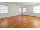 Bright bedroom with wood floors, three windows providing natural light, and neutral walls at 124 The Prado, Atlanta, GA 30309