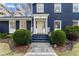 Elegant blue house featuring a classic entrance with columns, manicured bushes, and stone pathway at 124 The Prado, Atlanta, GA 30309