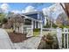 Charming blue home with white trim, picket fence, stone walkway, and well-manicured landscaping at 124 The Prado, Atlanta, GA 30309