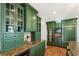 Well-lit kitchen featuring granite countertops and custom green cabinetry at 124 The Prado, Atlanta, GA 30309