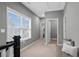 A carpeted hallway with natural light, a bench seat, and access to multiple rooms at 1968 Perry Nw Blvd, Atlanta, GA 30318