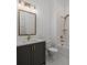 Elegant bathroom with a dark vanity, framed mirror, tub, and shower featuring bronze fixtures at 204 Wakehurst Way, Marietta, GA 30064