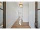 Inviting hallway features pristine white walls with dark trim and beautiful natural wood flooring at 204 Wakehurst Way, Marietta, GA 30064